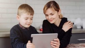 Mother-helping-son-with-teletherapy-as-facilitator