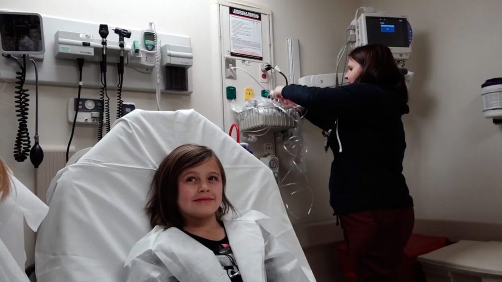 young girl sitting in hospital bed at Pikeville ED part of school tour