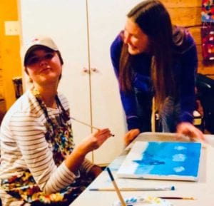 teen girl painting with instructor at HEARTism