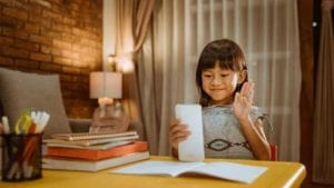 Little-girl-videoconferencing-telepractice-for-schools-and-education