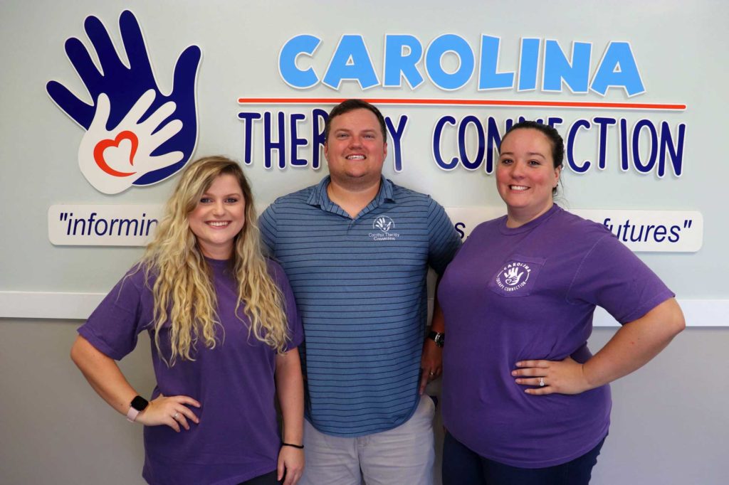 staff in front of sign