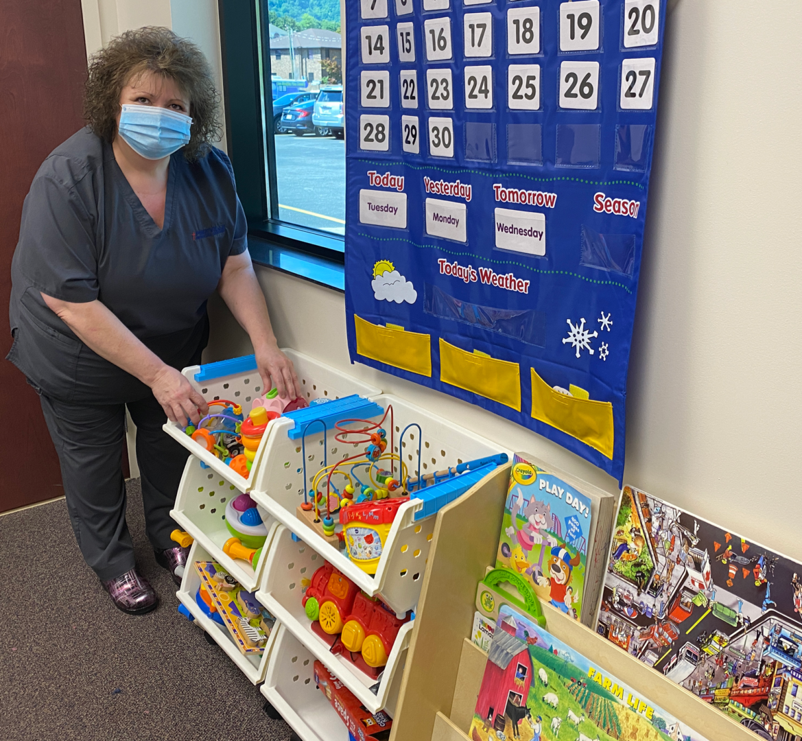 Staff Member setting up room with games and toys