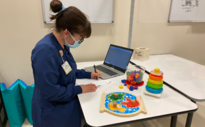 staff on computer with sensory toys