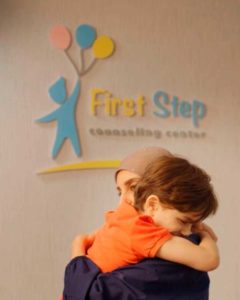 young patient hugging First Step staff