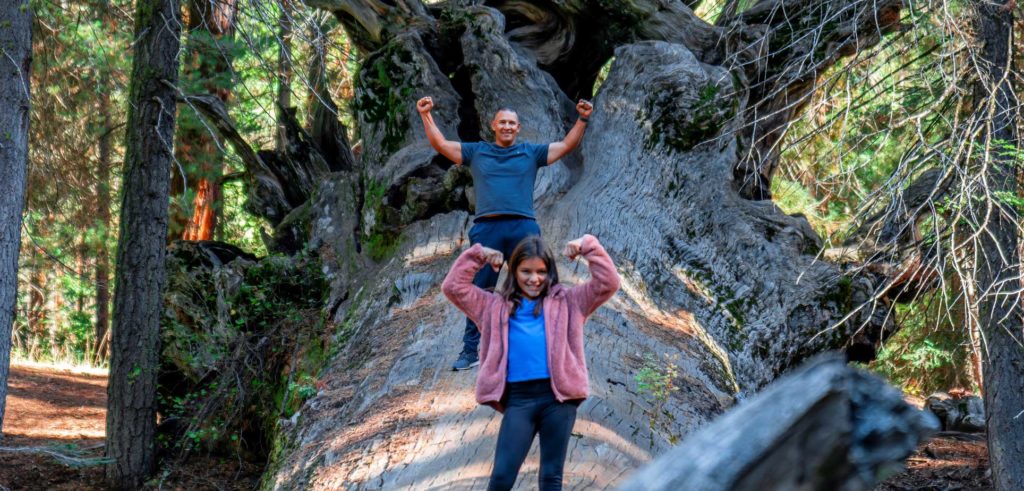 Visit Visalia father and daughter climbing big fallen tree