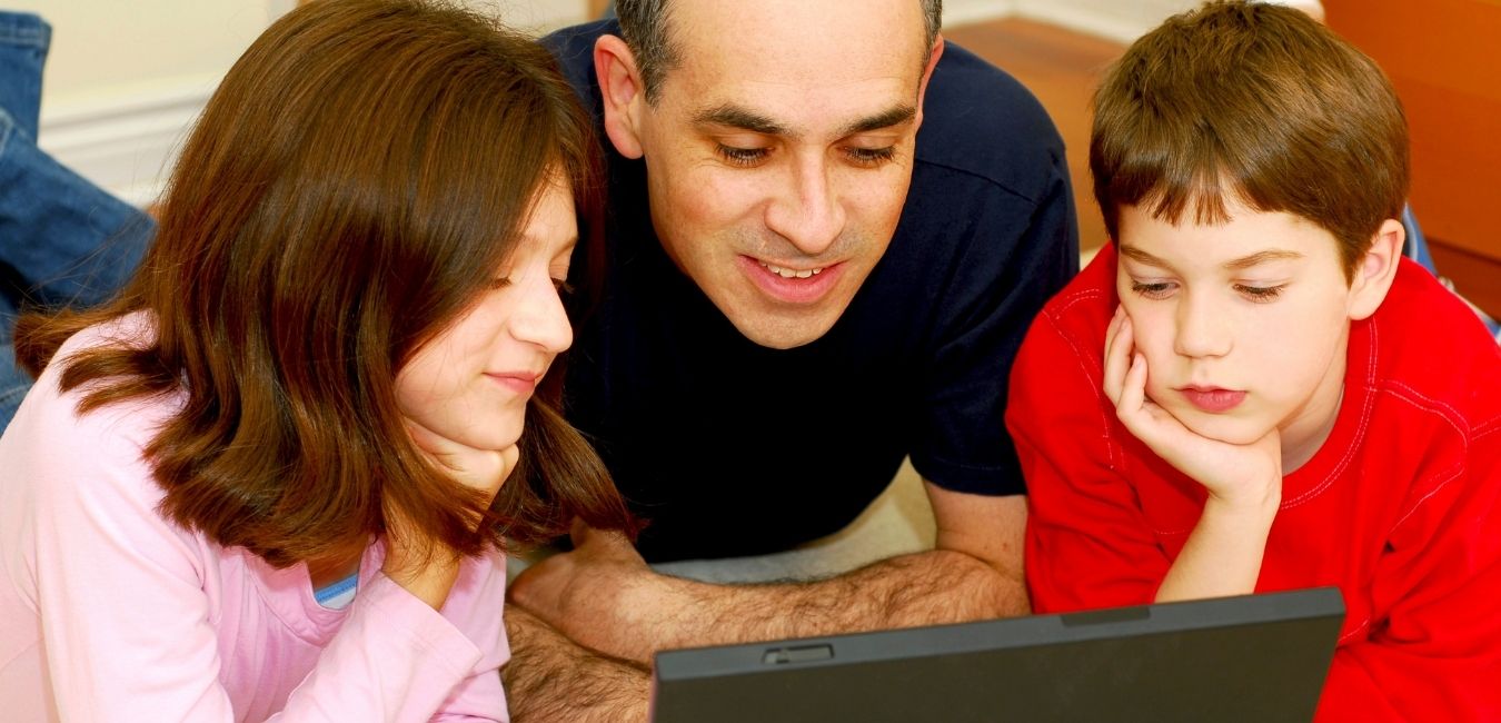 Dad assisting children