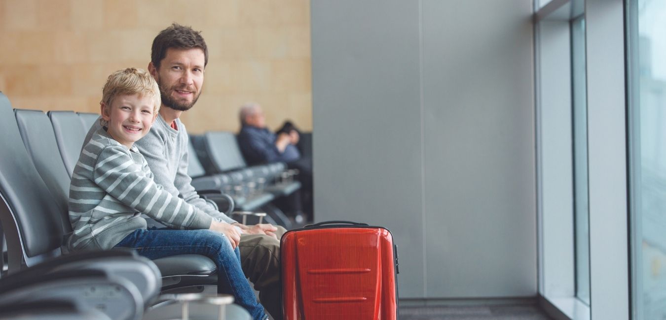 Father and son on queue while waiting for boarding