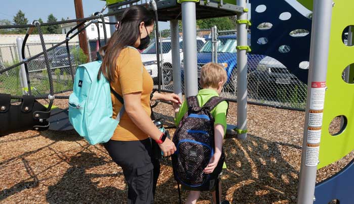 Firefly Autism staff with student on playground